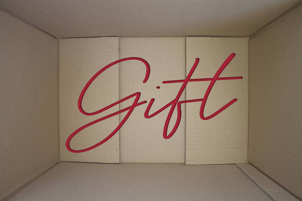 Gift word with cardboard box. Brown folded card box. - Photo, Image