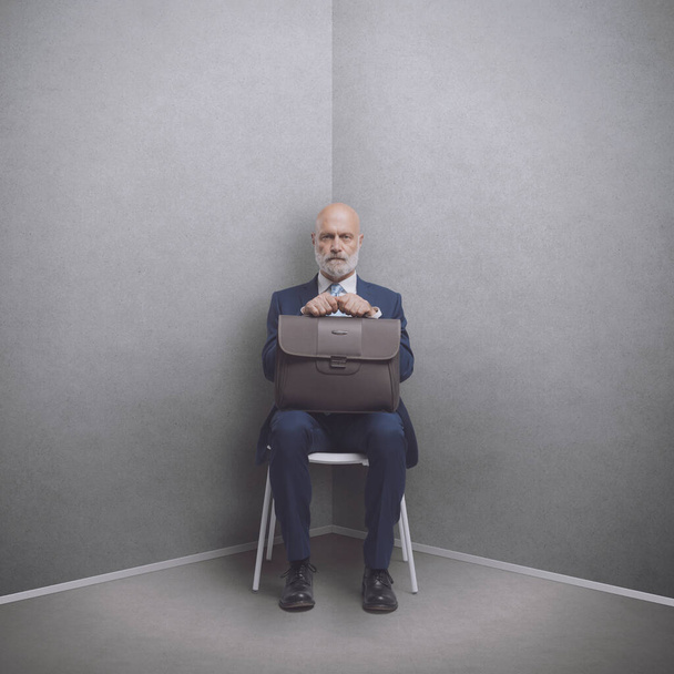 Senior corporate businessman sitting in a corner, job interview and meetings concept - Valokuva, kuva