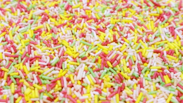színes cukorszálak szórja absztrakt háttér - Felvétel, videó