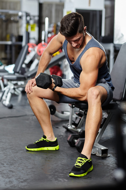 Man doing biceps workout in a gym - Фото, зображення