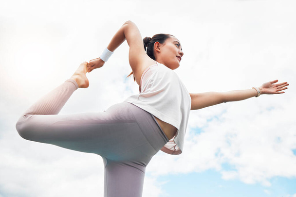 Yoga exercise woman and bow balance, stretching and outdoor fitness, wellness and mindfulness on cloud blue sky background. Below of healthy pilates training, strong body focus and zen mindset energy. - 写真・画像