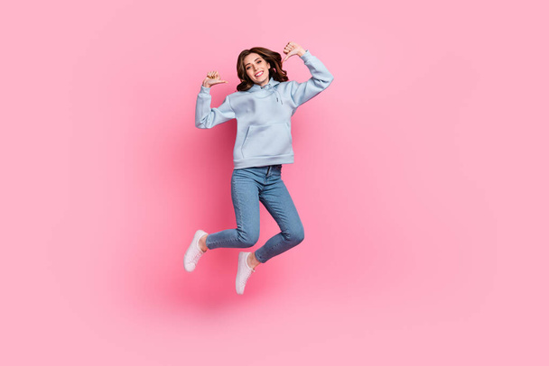 Full size portrait of crazy carefree girl jumping direct thumb fingers self herself isolated on pink color background. - Fotoğraf, Görsel