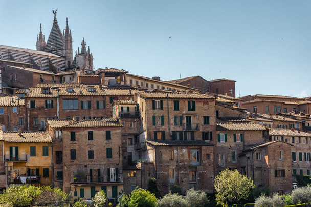 Siena, Italy, 17 April 2022: Beautiful cityscape of the medieval historic center - Fotoğraf, Görsel