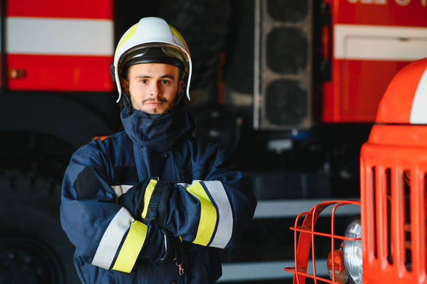 Photo of fireman with gas mask and helmet near fire engine. - Fotografie, Obrázek