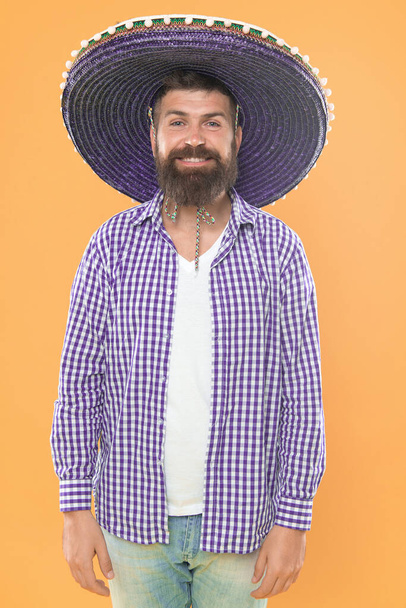 Man wear sombrero mexican hat. Mexican culture concept. Celebrate mexican holiday. Mexican bearded guy ready to celebrate. Customs and traditions. Sombrero wide brimmed hat provides plenty of shade. - Photo, image