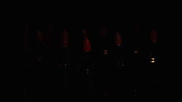 Red lipsticks in darkness on black background with copy space - Photo, Image