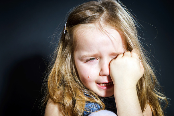 Crying blond little girl with focus on her tears - Photo, image