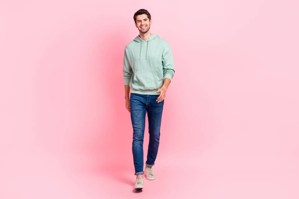 Full length photo of nice attractive man dressed grey outfit jeans pants go boutique want renew wardrobe isolated on pink color background. - Fotó, kép