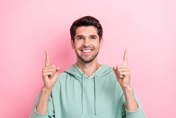 Photo of positive nice person beaming smile look direct fingers up empty space isolated on pink color background. - Фото, изображение