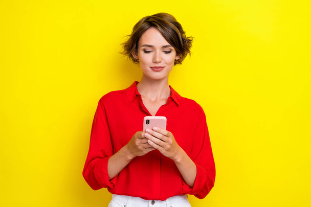 Photo of nice positive cute lovely girl with bob hairdo dressed red shirt chatting video call webcam isolated on yellow color background. - Valokuva, kuva