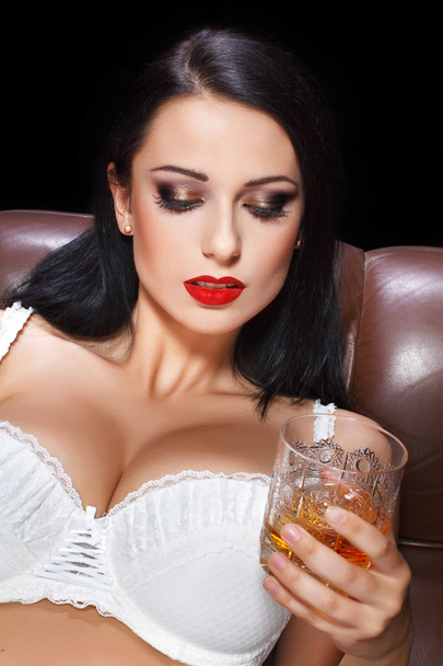 Sexy woman with glass of whiskey - Photo, image