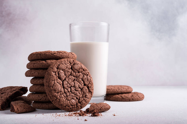 Homemade tasty american chocolate cookies with glass of milk on grey concrete background - Photo, image