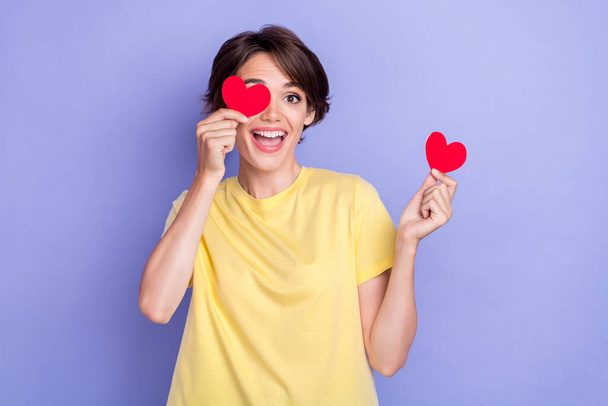 Photo of young attractive pretty cute nice woman hold two paper hearts excited good mood cover face laugh amour isolated on purple color background. - Фото, зображення
