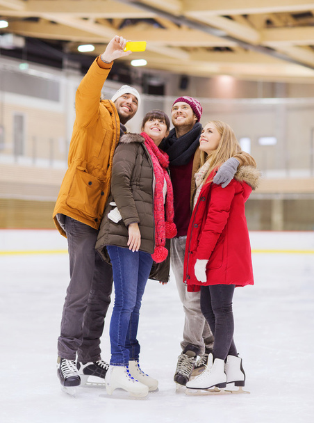 happy friends taking selfie on skating rink - Zdjęcie, obraz