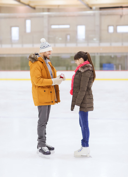happy couple with engagement ring on skating rink - Foto, Imagem