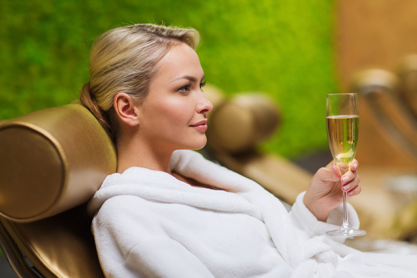 beautiful young woman drinking champagne at spa - 写真・画像