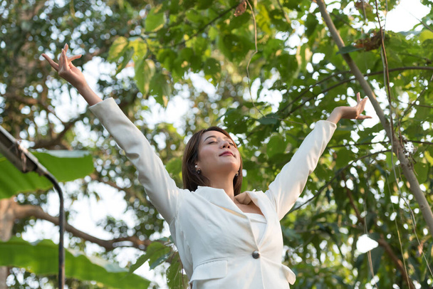 Happy woman raised arms enjoying the beautiful morning outdoors, I can do it, keep fighting, everything can be success, healthy life balance. - Photo, Image