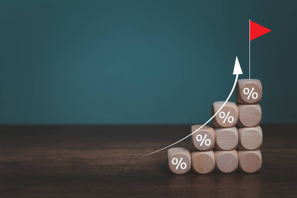 Interest financial rate and mortgage rates concept, Wooden blocks with Icon percentage symbol and arrow pointing up. The economy is improving. - Photo, Image