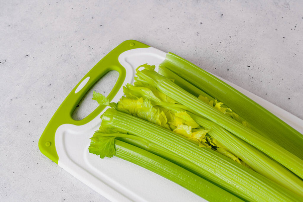 Stalk of celery close-up on cutting board, view from above, copy space - Foto, Bild