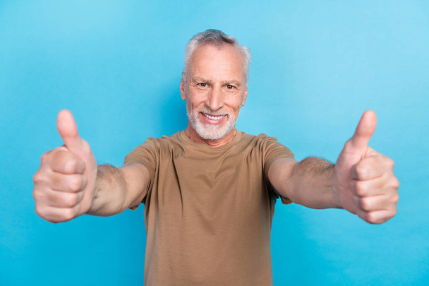 Portrait of satisfied attractive retired man dressed pastel clothes two arm demonstrate yes symbol isolated on blue color background. - Foto, Imagen
