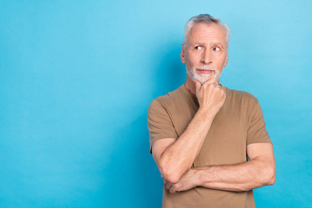 Portrait of concentrated focused man interested look empty space dilemma doubt uncertain unsure hmm space isolated on blue color background. - Foto, Imagen
