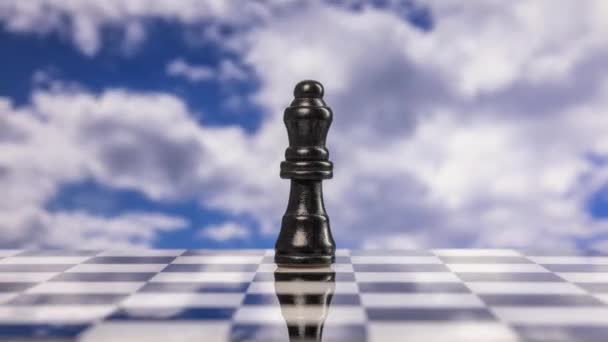 Chess pieces moving towards and away from the camera with passing clouds behind - Footage, Video