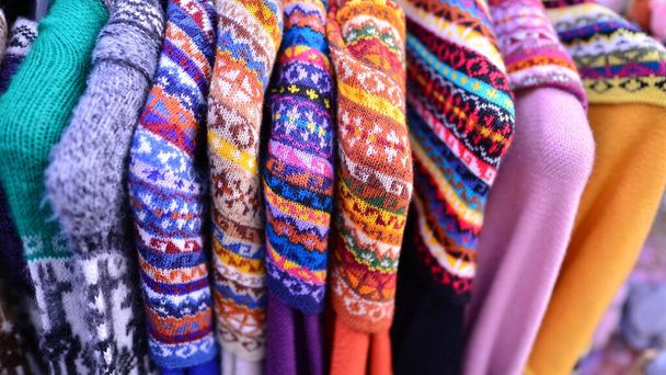 Made in Peru handicraft woolen, jackets, sweaters and vests made from alpaca with traditional design at market. - Photo, Image