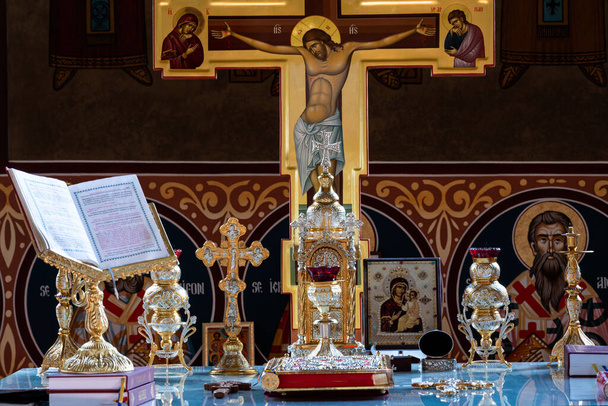 Ortodoksisen kirkon alttarin sisällä, jossa on perinteisiä esineitä ja koristeltu risti ja seinät.. - Valokuva, kuva