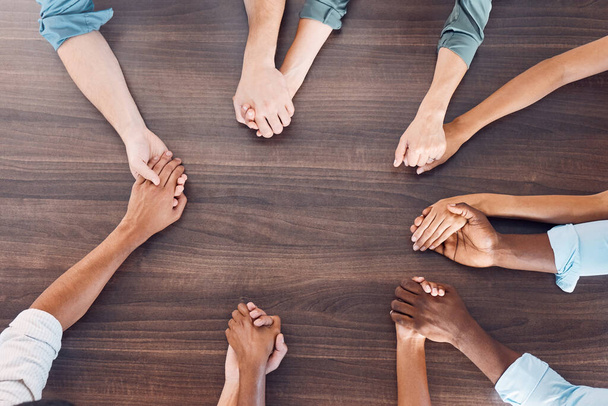 Top view, holding hands or mental health support in group therapy meeting for psychology, trust or security. Men, women and diversity people in prayer circle for community, anxiety or depression help. - Foto, Imagem