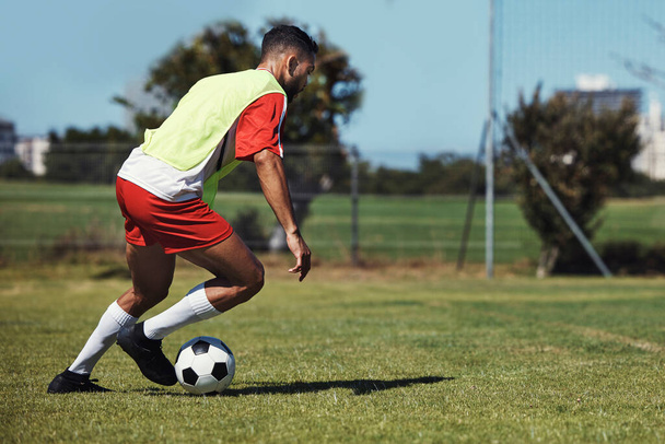 Man, running or soccer ball on grass field for sports, training or workout in competition match. Football player, athlete or fitness person in workout, training or exercise for wellness or speed game. - Photo, Image