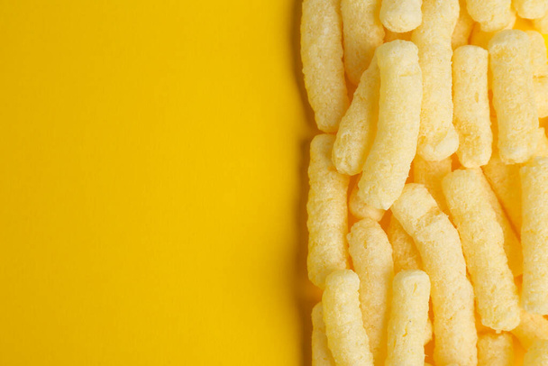 Tasty corn sticks on yellow background, top view. Space for text - Фото, зображення