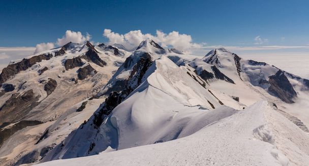 Красивые альпийские пейзажи в швейцарских Альпах зимой, с впечатляющим облачным пейзажем - Фото, изображение