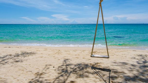 Low hanging palm tree with a swing on the Island of Koh Kood tropical Island in the province of Trat East Thailand - Photo, Image