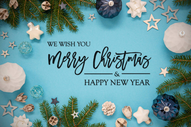 Christmas Card With English Text Merry Christmas And Happy New Year. Turquoise And Blue Background With Ornaments And Decoration Like Spruce And Fir Tree Branch, Balls And Stars. - 写真・画像
