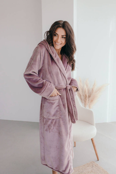 Young healthy serene woman girl relaxing in bathrobe and spa towel after having bath shower at home. Beauty treatment, rest and body care procedures. High quality photo - Foto, imagen