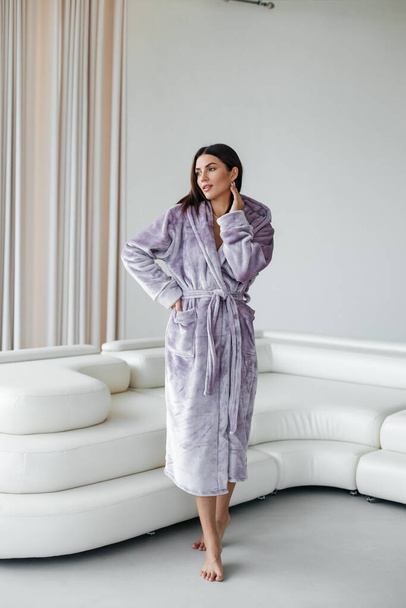 Young healthy serene woman girl relaxing in bathrobe and spa towel after having bath shower at home. Beauty treatment, rest and body care procedures. High quality photo - Foto, Bild