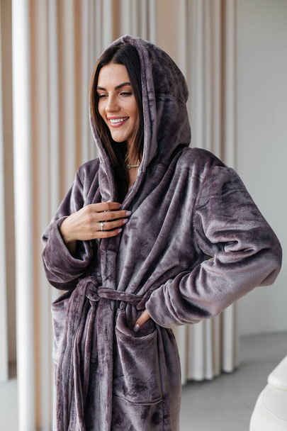 Young healthy serene woman girl relaxing in bathrobe and spa towel after having bath shower at home. Beauty treatment, rest and body care procedures. High quality photo - Photo, image