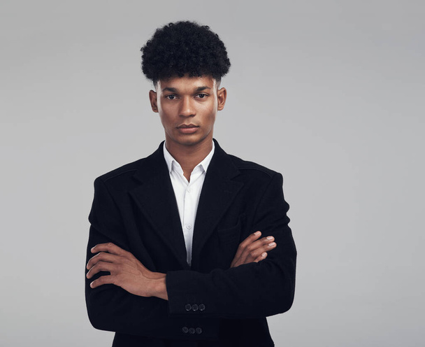 I say what I mean and mean what I say. Studio portrait of a confident young businessman posing against a grey background - Foto, Bild