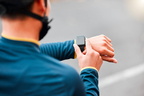 Watch, fitness and man doing a workout, exercise or outdoor cardio in the city road for motivation. Hands of an athlete with monitor of time during training with sports technology in the street. - Foto, Imagen