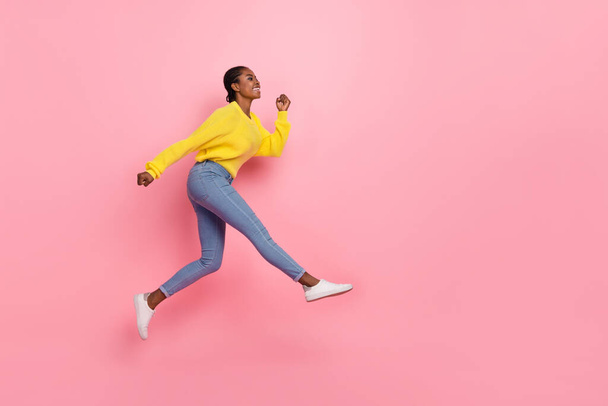 Full body profile side photo of young cheerful girl run rush speed motion look empty space jump isolated over pink color background. - Zdjęcie, obraz