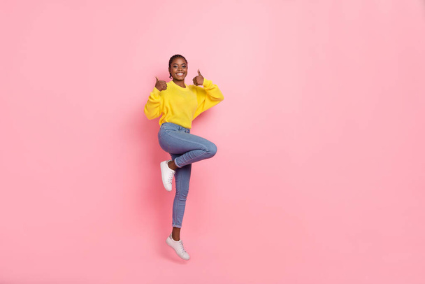 Full length photo of young pretty girl jump show fingers thumb-up select approve ideal isolated over pink color background. - Fotoğraf, Görsel