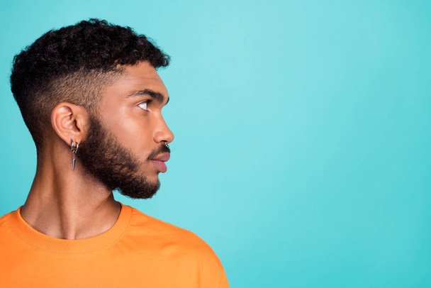 Close up profile side photo of serious confident man wear orange clothes satisfied hairdo look empty space isolated cyan color background. - Foto, Imagen