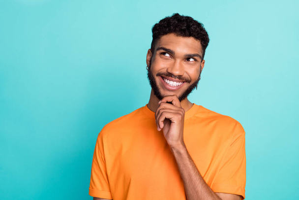 Close up photo of attractive positive man wear trendy clothes look up empty space interesting news isolated on cyan color background. - Foto, Imagem
