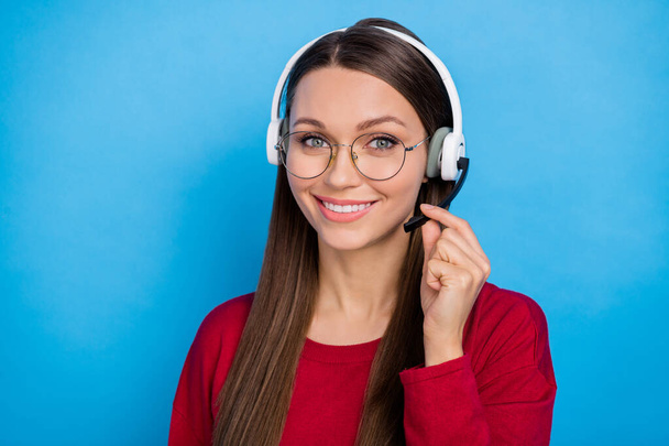 Photo of sweet young lady wear headphones spectacles burgundy shirt isolated on blue color background. - Photo, image