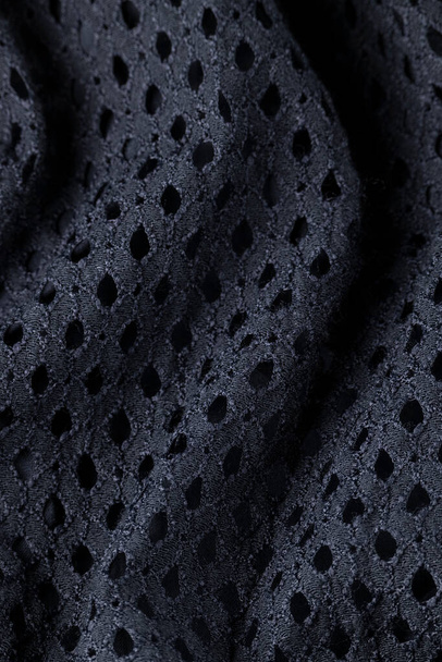 Modieuze zwarte doek, ondulate moderne textiel close-up uitzicht - Foto, afbeelding