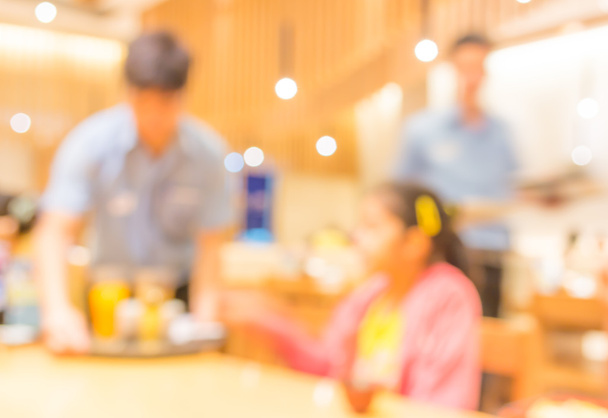 Blurred background image of young customer sit in restaurant - Photo, Image