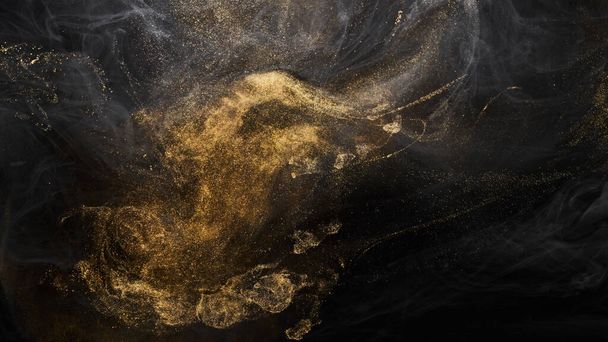 Golden sparkling abstract background, luxury black smoke, acrylic paint underwater explosion, cosmic swirling ink - Photo, image