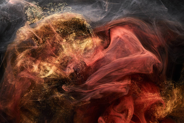 Red black sparkling abstract background, luxury golden smoke, acrylic paint underwater explosion, cosmic swirling ink - 写真・画像