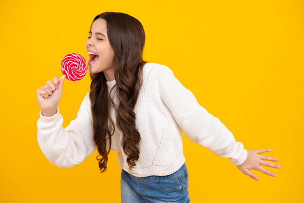 Funny face. Teenager girl with caramel candies on sticks, sweet sugar addiction. Child with lollipops - Photo, Image