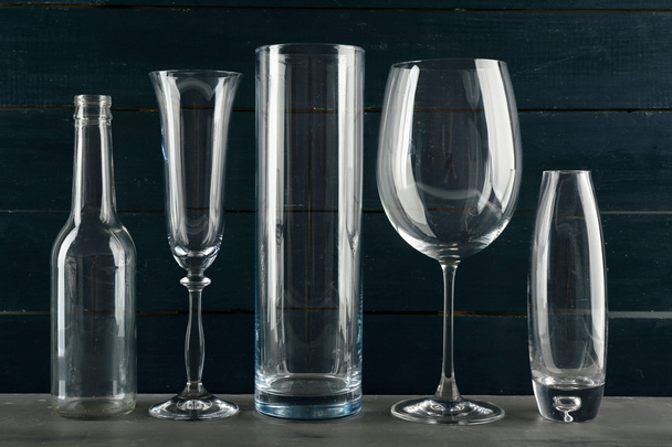 Different glassware on dark color wooden background - Valokuva, kuva